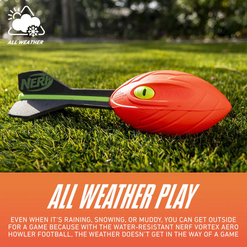 Vortex Aero Howler Foam Football With Mega Distance Passes Flight Tail on grass, showing vibrant orange color and easy grip.