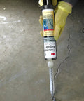 Person applying DP600 Gray Self-Leveling Concrete Repair Sealant Cartridge With 2 Mix Nozzles 8.4 Fl Oz to a concrete crack