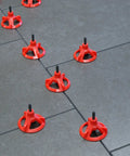 Tile Leveling System With One Eighth Inch Spacer Posts, 250 Pieces, Black Baseplates And Caps Sold Separately in action on tiles.