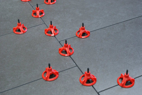 Tile Leveling System With One Eighth Inch Spacer Posts, 250 Pieces, Black Baseplates And Caps Sold Separately in action on tiles.