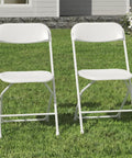 White Plastic Folding Chairs 2 Pack For Indoor And Outdoor Use 350 Pound Capacity on grass