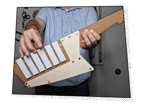 Keytar Invention Launchpad Starter Bundle For Hands On STEM Coding Learning Build Your Own Musical Instrument Kit That Lets Kids Create Code Play And Customize An Educational Instrument, wooden keytar held in hands