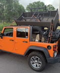 Orange Jeep carrying camping gear secured with Heavy Duty Bungee Cords With Hooks 3 Pack, 3 Ft 4 Ft 5 Ft Multiloop Tie Down System.