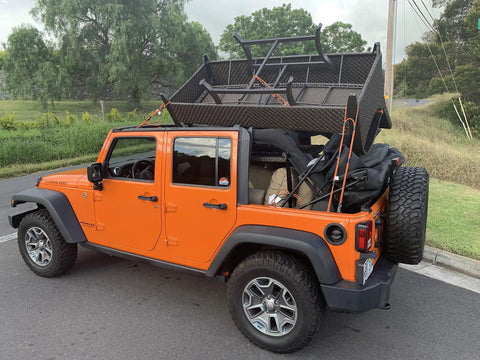 Orange Jeep carrying camping gear secured with Heavy Duty Bungee Cords With Hooks 3 Pack, 3 Ft 4 Ft 5 Ft Multiloop Tie Down System.