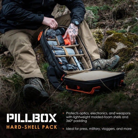 Impact-Resistant Hardshell Camera And Drone Backpack With External Mounting System, open showing organized compartments in rugged terrain.