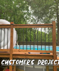 Customer's deck with 32 Inch Hollow Round Iron Deck Balusters 25 Pack Matte Black For Deck Railing Porch Staircase Banister Balustrade Tough As Nails Outdoor Ready Powder Coated AAMA 2604 Durable Finish, featuring a pool in the background.