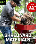 Man using Heavy Duty 212cc 4 Cycle Chipper Shredder With 20 To 1 Reduction Turns Branches Up To 3 Inches Into Mulch, Airless Wheels