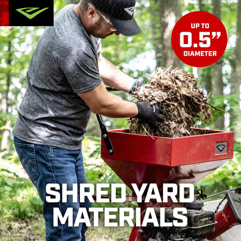 Man using Heavy Duty 212cc 4 Cycle Chipper Shredder With 20 To 1 Reduction Turns Branches Up To 3 Inches Into Mulch, Airless Wheels