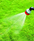 Long Metal Garden Wand With Seven Watering Patterns, Thumb Control, 180 Degree Adjustable Head, spraying water on grass