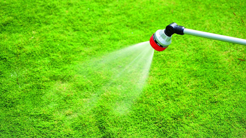 Long Metal Garden Wand With Seven Watering Patterns, Thumb Control, 180 Degree Adjustable Head, spraying water on grass