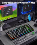 94 Key Wired RGB Gaming Keyboard Delivering Crisp Mechanical Feel And Snappy Anti Ghosting Action Alongside Four Custom Macro Keys And Large Numpad For A Truly Squad Approved Desk Setup on a minimalist desk with dual monitors.