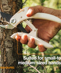 Bypass Pruner With PowerLever And Lightweight FiberComp Handles cutting a tree branch for gardening precision.