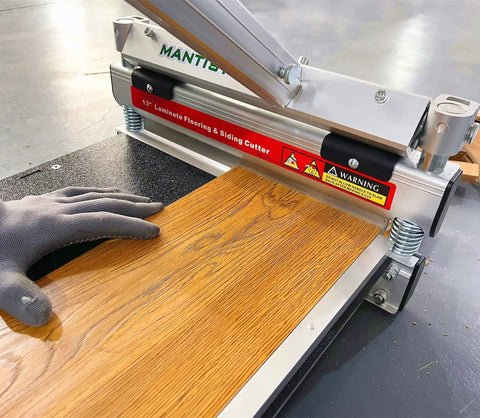Pro Grade Floor Cutter For Laminate And Vinyl With Quick Install Kit cutting laminate plank at 45 degrees, with gloved hand