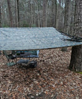 Heavy Duty Waterproof Tarp With Bionic Tree Camo Pattern, Multi Purpose Poly Cover 10 Mil Thick creating outdoor shelter.