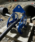 Heavy Duty Cable Puller Sheave For Smooth Wire Rope Pulling And Cable Feeding Industrial Grade Workhorse Wheel With Stainless Steel Rollers On A Blue Powder Coated Steel Frame For Rugged Material Handling in use at a construction site
