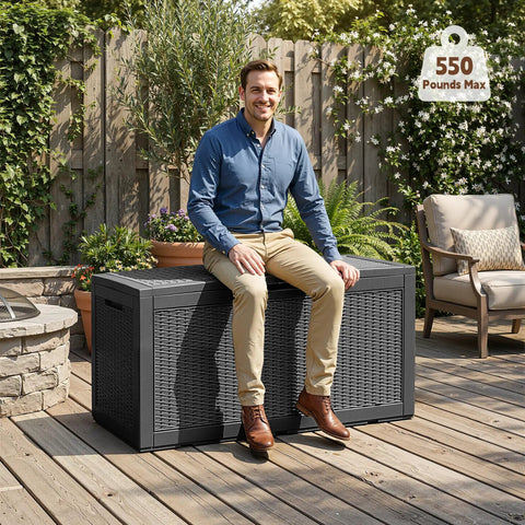 100 Gallon Outdoor Storage Box With Lockable Lid And Hydraulic Struts Resin Deck Box used as seating on patio with man sitting.