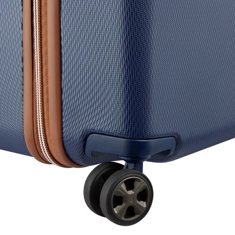 Delsey 26-inch spinner luggage corner with wheel and basketweave texture showcasing durability and style in navy blue.