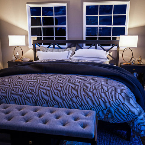 Oke Table Lamp With Gold Plated Finish, Modern Art Deco open round frame on bedroom nightstands, white rectangular shades, night view.