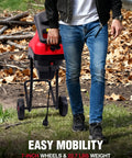 Man walking with Electric Wood Chipper Shredder For Home Yard Cleanup With A 15 Amp Motor on wheels, leaves on ground