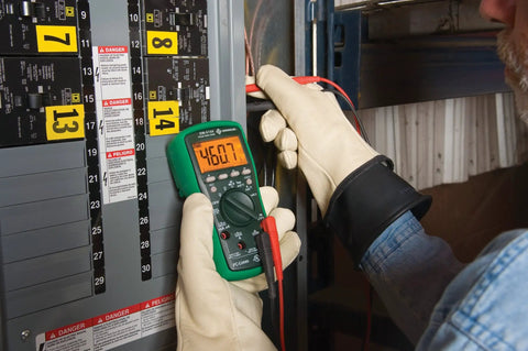 Technician using True RMS Digital Multimeter for Pros Pro Grade DMM AC DC Voltage Current Resistance Capacitance and Temperature 6000 Count LCD