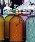 Green Stainless Steel Regulator Valve Handle for Scuba Diving Tank Replacement among colorful gas cylinders.