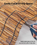 Cutting Natural Reed Fencing Roll 4 Ft By 16.4 Ft 3 Pack Outdoor Privacy Screen Panels for Balcony Patio Garden with scissors.