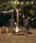 Two purple Heavy Duty High Back Folding Camp Chairs with Cup Holder and Cooler Bag around campfire under string lights