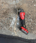 Concrete surface with visible crack and power tool on top, showing repair process for 2X Concrete Crack Sealant Easy To Use No Mess Ready Mixed Filler For Cracks Up To Half Inch Self Leveling Gray Finish Traffic Ready In 30 To 45 Minutes Ideal For Driveways Patios And Concrete Surfaces