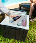 9 Gallon Outdoor Beverage Cooler with Insulated Ice Chest that Holds 40 Cans for Backyard Parties, shown open by a poolside.