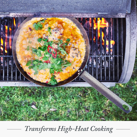 Budget-Friendly Carbon Steel Frying Pan 12 Inch pre-seasoned with food on grill, campfire ready for searing and grilling