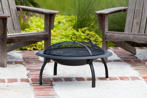 Portable Folding Fire Pit 29 Inch Round Steel Fire Bowl With Folding Legs for backyard use, brick patio setting.