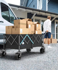 Heavy Duty 48 Inch XL Collapsible Wagon Cart With All Terrain Wheels And 560 Lb Capacity For Camping, Beach, Garden, Sports, Shopping And More Built To Haul Heavy Gear Everywhere loaded with boxes.