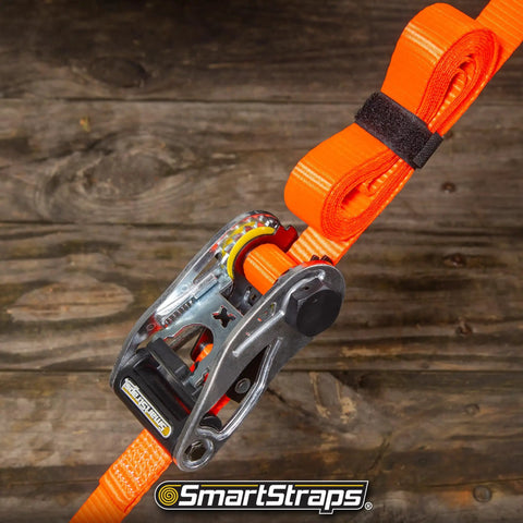 Close-up of orange SmartStraps 14Ft Premium Ratchet Strap Set with metal ratchet, showing details for hauling heavy loads.
