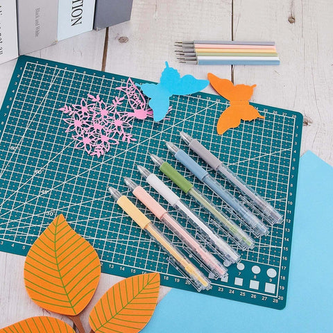 Lanties six-piece precision craft knife set with colored grips on a green cutting mat beside paper butterfly and leaf cutouts.