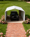 Heavy Duty Metal Garage And 20 X 30 Foot Steel Carport featuring a black vehicle under the 14 gauge frame with flower beds.