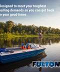 Person fishing on a lake near blue boat, showcasing the need for Boat Trailer Winch 1800 Lb Capacity With 20 Ft Winch Strap And Hook