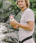 Person holding Orienteering Compass For Hiking With Luminous Needle And Mirror All In One Portable Navigation Tool With Scale Ruler