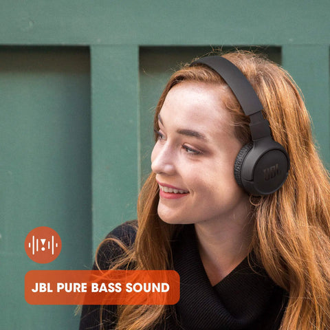 Person wearing black Wireless Bluetooth Cans With Up To 40 Hours Battery, Built-In Microphone For Calls, Foldable And Ultra Comfortable.