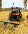 60 Inch Tow Behind Lawn Dethatcher With 24 Heavy Duty Spring Steel Tines For Quick Thatch, Leaves, Debris Cleanup Behind Your Lawn Or Garden Tractor Made For Easy, No Sweat Yard Work attached to a tractor in a field.