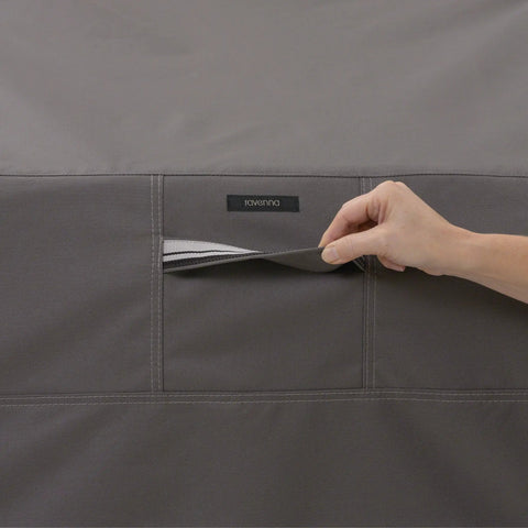 Close-up of Ravenna Water Resistant 58 Inch Patio Sofa Loveseat Cover's fabric pocket with hand demonstrating opening.
