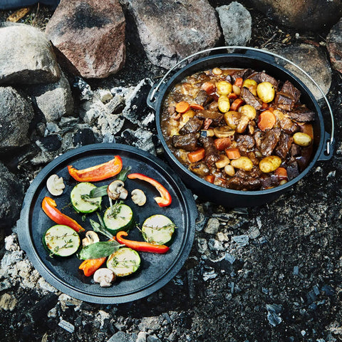 Six Quart Cast Iron Camping Dutch Oven with lid lifter and storage bag for campfire cooking stews and baking