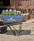 Five Cubic Foot Heavy Duty Garden Cart With 15 Inch Flat Free Tire filled with flowers, durable steel frame wheelbarrow