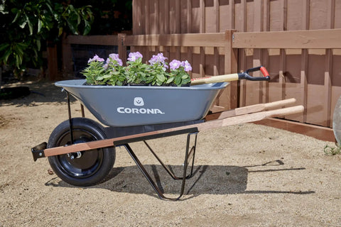 Five Cubic Foot Heavy Duty Garden Cart With 15 Inch Flat Free Tire filled with flowers, durable steel frame wheelbarrow