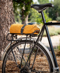Bike with rack secured using All Purpose Utility Strap 18 Inch Tie Down With 70 Lb Load Capacity Ideal For Securing Bikes Gear Skis Tarps Ladders Cords And More On Racks Or In The Garage Heavy Duty Yet Stretchy And Easy To Use.