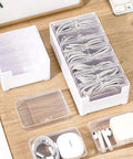 Clear Cable Organizer Storage Box With 7 Wire Ties, showing compartments and neatly arranged cables on a wooden desk.
