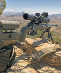 Rifle resting on Rear Squeeze Shooting Bag For Long Range Rests And Barricade Support PRS Style Precision in outdoor setting.