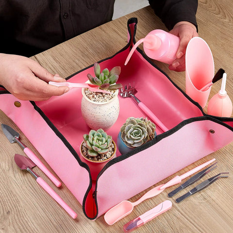 24 Piece Mini Garden Tools Kit For Succulents And Fairy Gardens with pink tarp mat and tools in use for planting indoors