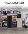Workhorse Stand Up Upright Freezer Five Cubic Feet With Reversible Door in a garage setting with storage items around.