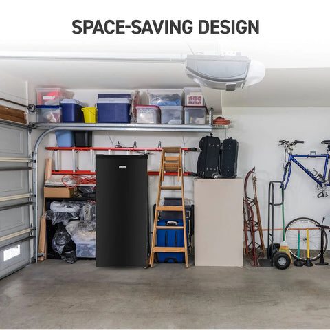 Workhorse Stand Up Upright Freezer Five Cubic Feet With Reversible Door in a garage setting with storage items around.
