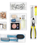 Clear Set Of 6 Modular Drawer Organizers For Home Office Cosmetics Utensils And Craft Supplies Durable Resin Storage Tray Dividers To Keep Drawers Neat And Clutter Free filled with assorted items like tools and cosmetics.